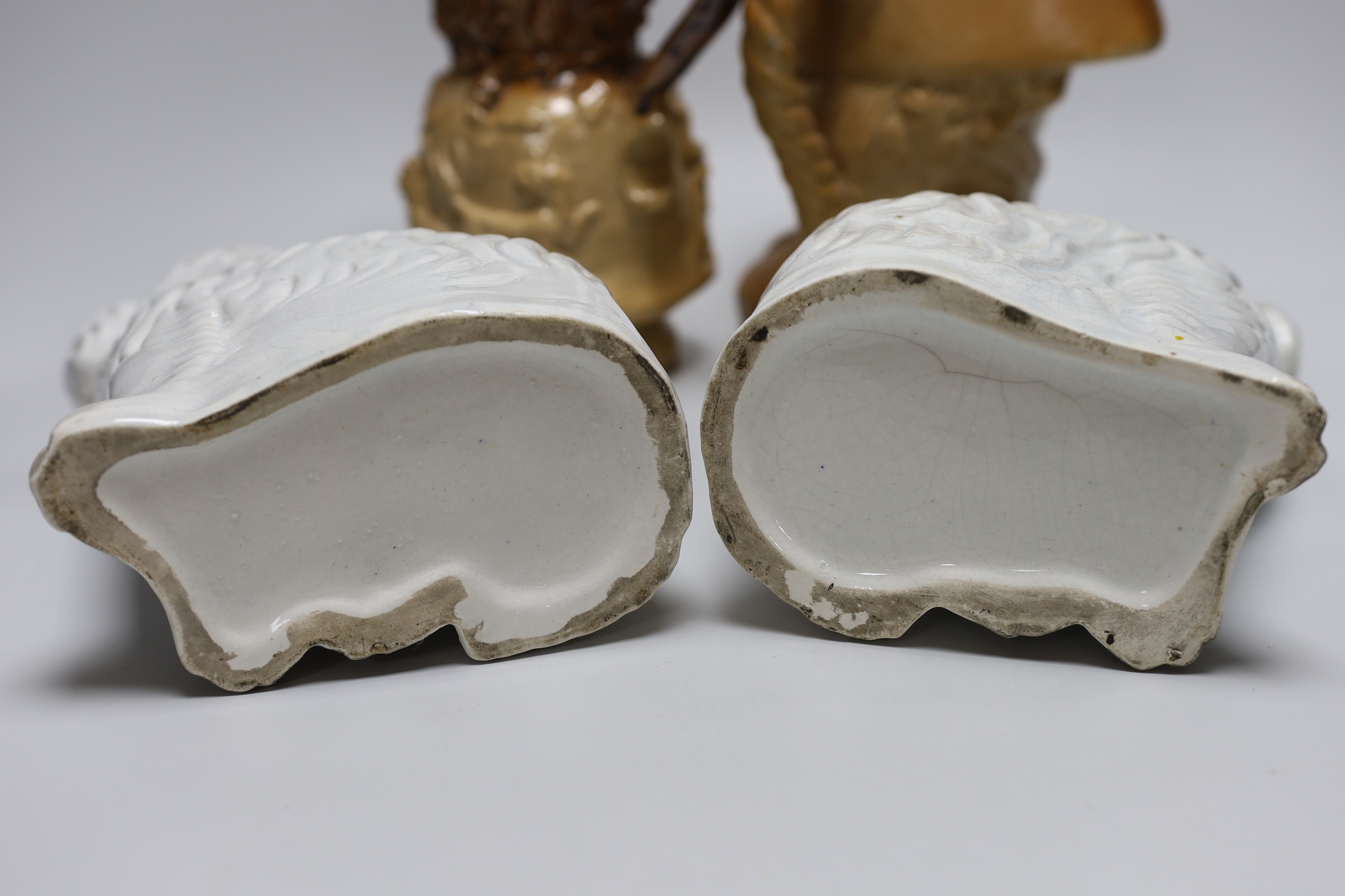 A Doulton and Watts glazed stoneware bust of Lord Nelson, a pair of white glazed Staffordshire pottery dogs and a Victorian earthenware jug (4)